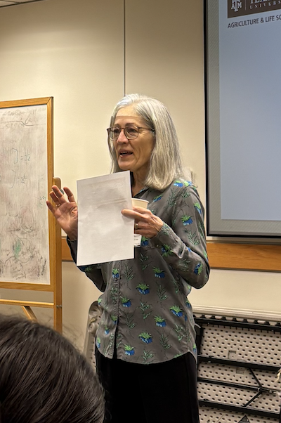 Image of Nancy Moran giving opening remarks at the symposium