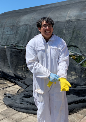 Photo of Alejandro in a beesuit