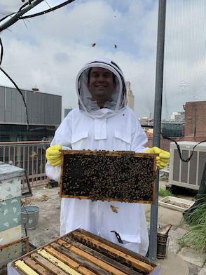 Photo of Jeff Barrick holding a bee frame