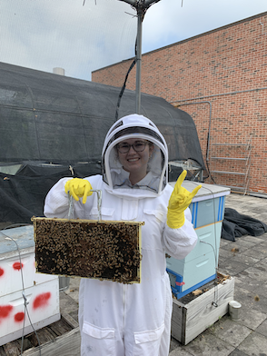 Photo of Kadena C. holding a bee frame